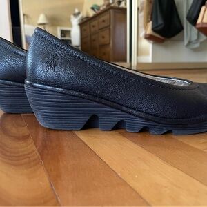 Fly London black leather wedge slip ons